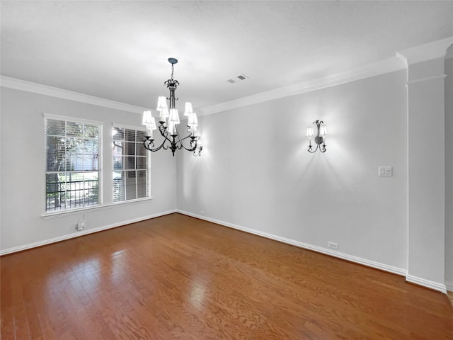 unfurnished room with crown molding, hardwood / wood-style flooring, ornate columns, and an inviting chandelier