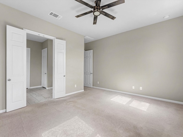 unfurnished bedroom featuring light colored carpet and ceiling fan