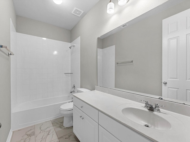 full bathroom featuring tiled shower / bath, vanity, and toilet