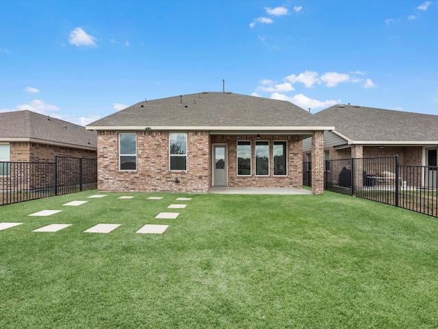 rear view of property featuring a patio and a lawn