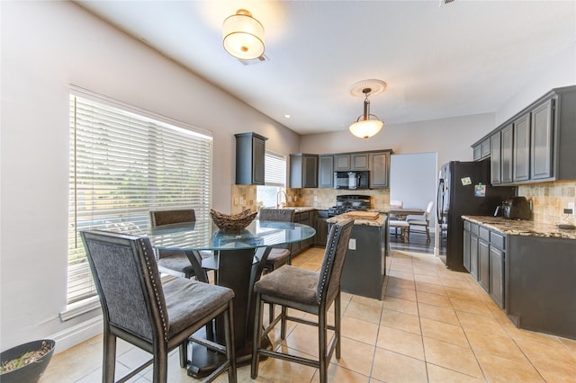 tiled dining room featuring sink