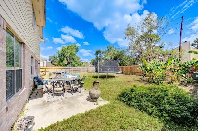 view of yard with a patio and a trampoline