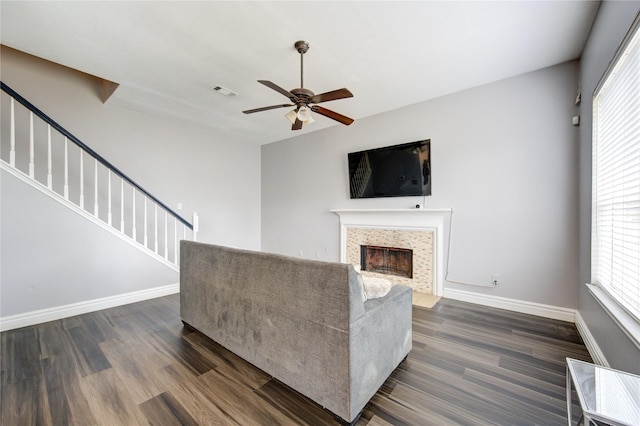 unfurnished living room with dark wood-type flooring and ceiling fan