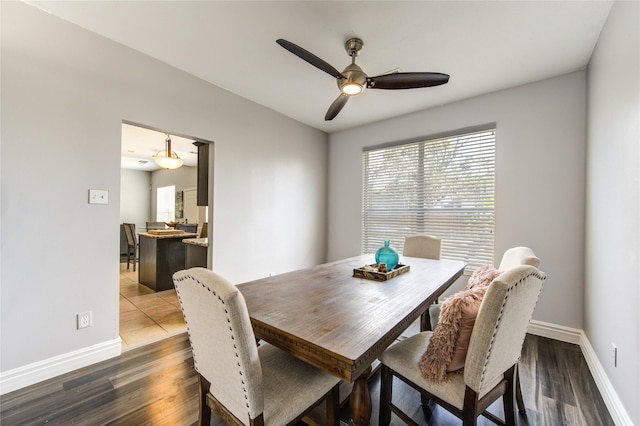 dining area with dark hardwood / wood-style flooring and ceiling fan