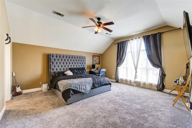 bedroom with ceiling fan, lofted ceiling, and carpet flooring