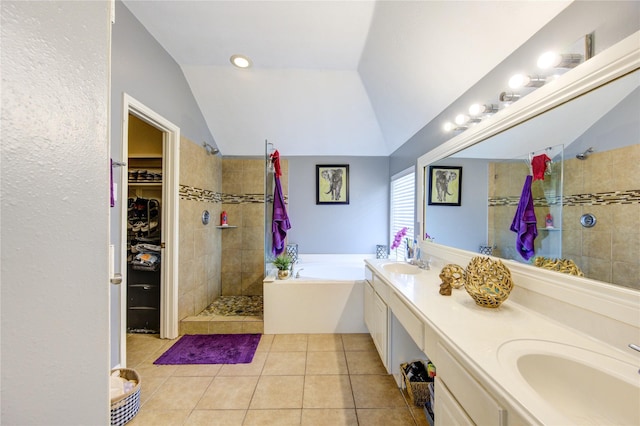 bathroom with plus walk in shower, lofted ceiling, tile patterned floors, and vanity