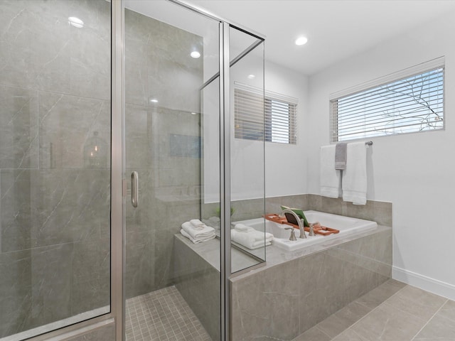 bathroom with independent shower and bath and tile patterned flooring