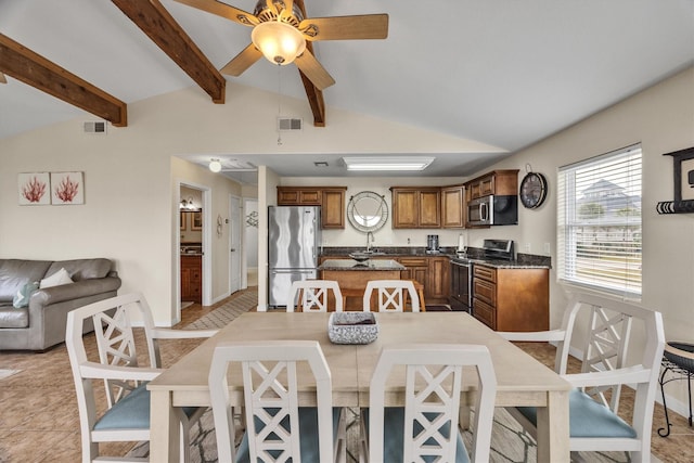 dining area with ceiling fan and lofted ceiling with beams