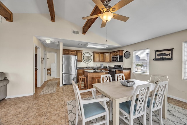 dining room with light tile patterned flooring, ceiling fan, and lofted ceiling with beams