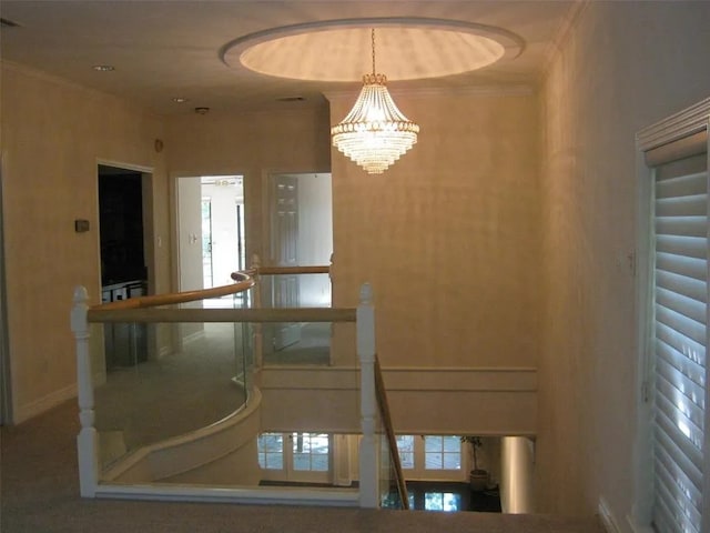 interior space with ornamental molding and a chandelier