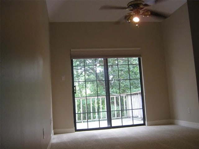 unfurnished room with ceiling fan and carpet flooring