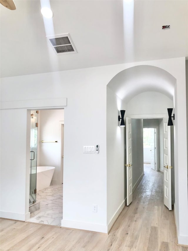 2221 Bevis St, Houston, TX 77008 - hall featuring arched walkways and light wood-style floors