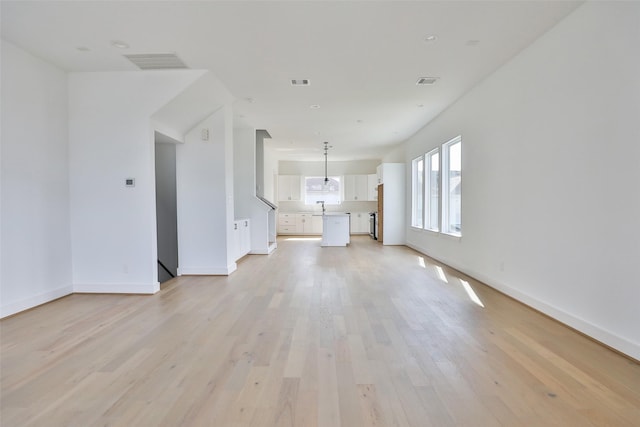 unfurnished living room featuring light wood-type flooring