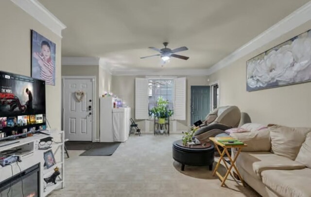 living room with a ceiling fan, carpet floors, and ornamental molding