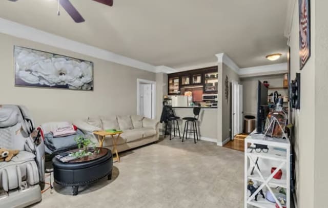 living room featuring ornamental molding and a ceiling fan