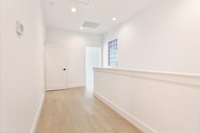 corridor with recessed lighting, visible vents, baseboards, light wood-type flooring, and attic access