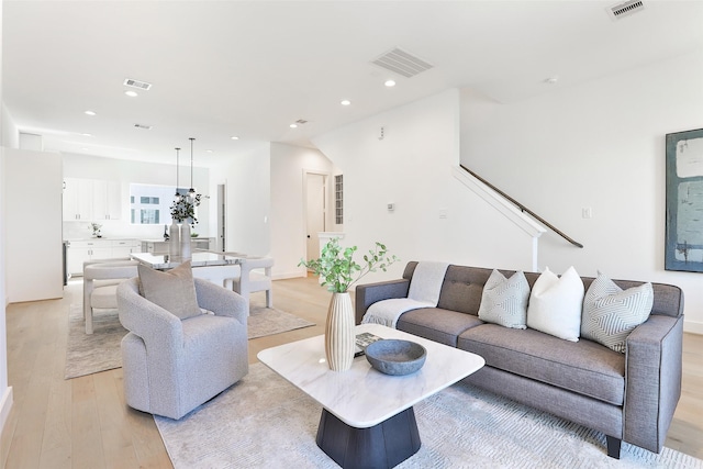 living room featuring recessed lighting, visible vents, and light wood finished floors