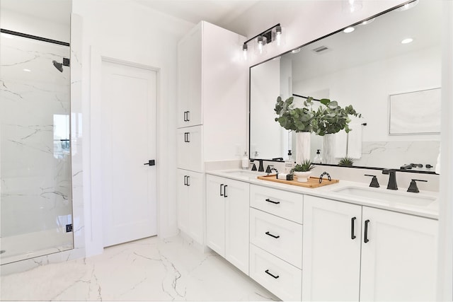 full bathroom featuring double vanity, marble finish floor, a marble finish shower, and a sink