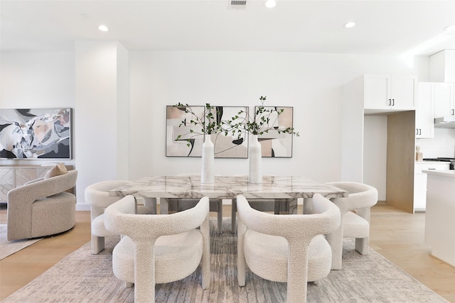 dining area with light wood-type flooring, visible vents, and recessed lighting