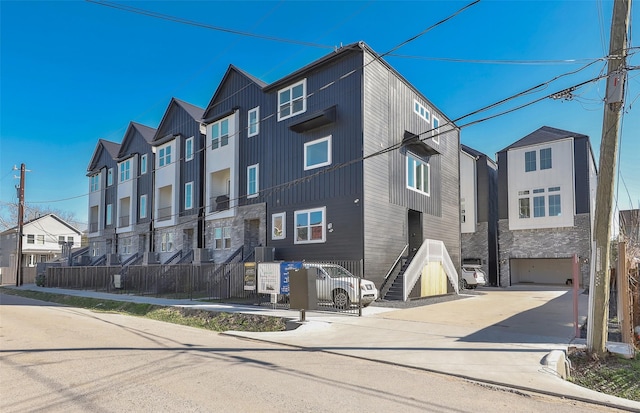 exterior space featuring stone siding, a residential view, and central AC unit