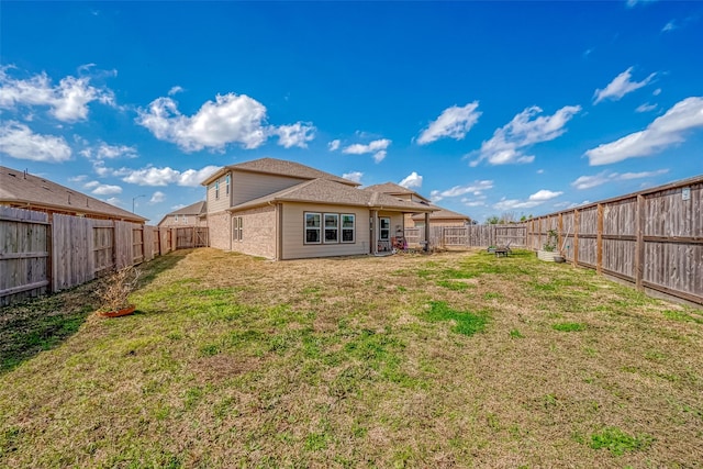 rear view of property featuring a yard