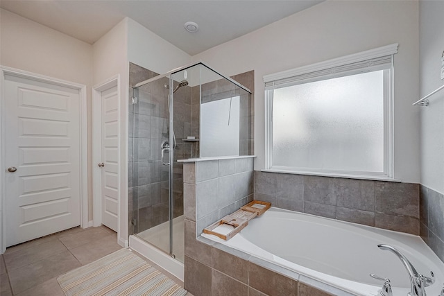 bathroom with tile patterned floors and independent shower and bath