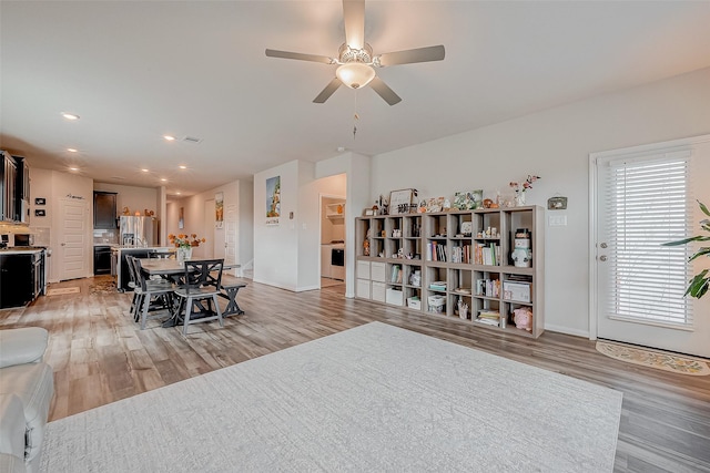 dining room with ceiling fan and light wood-type flooring