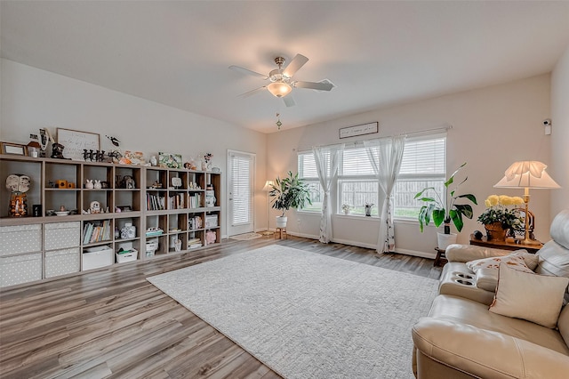 living room with ceiling fan and light hardwood / wood-style floors