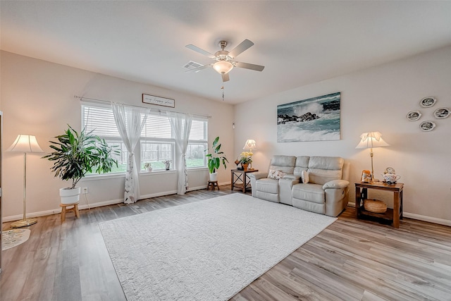 living room with ceiling fan and light hardwood / wood-style floors