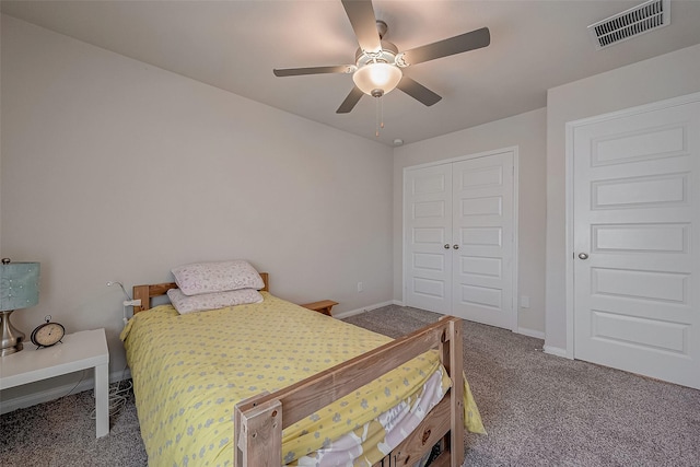 carpeted bedroom with ceiling fan and a closet