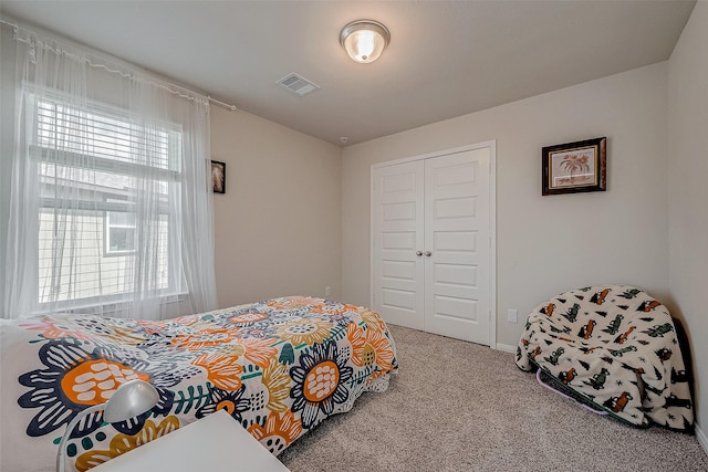 bedroom featuring carpet and a closet