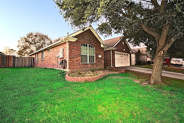 view of front of house featuring a garage and a lawn