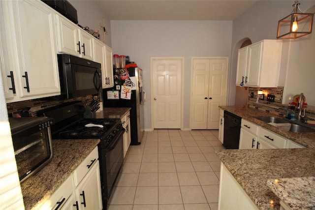 kitchen featuring stone counters, white cabinets, hanging light fixtures, and black appliances