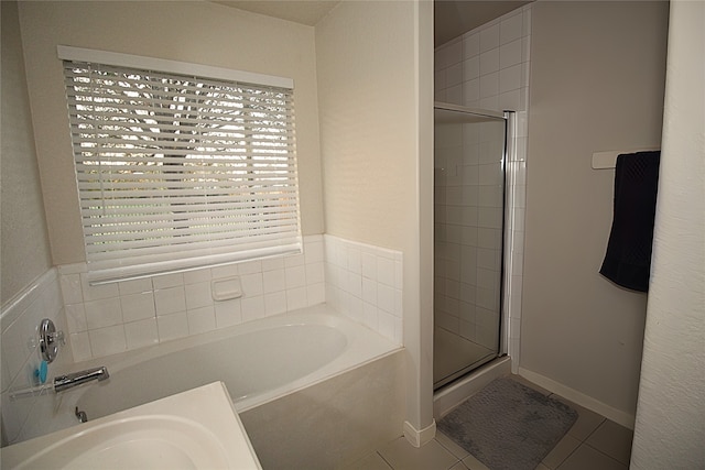 bathroom with tile patterned flooring and independent shower and bath