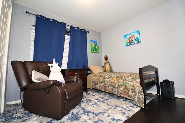 bedroom with dark hardwood / wood-style flooring