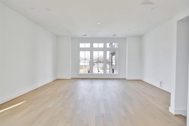 empty room with light hardwood / wood-style floors