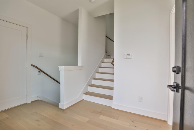 stairs with baseboards and wood finished floors