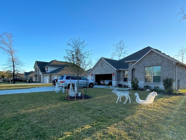 back of property with a garage, brick siding, and a yard