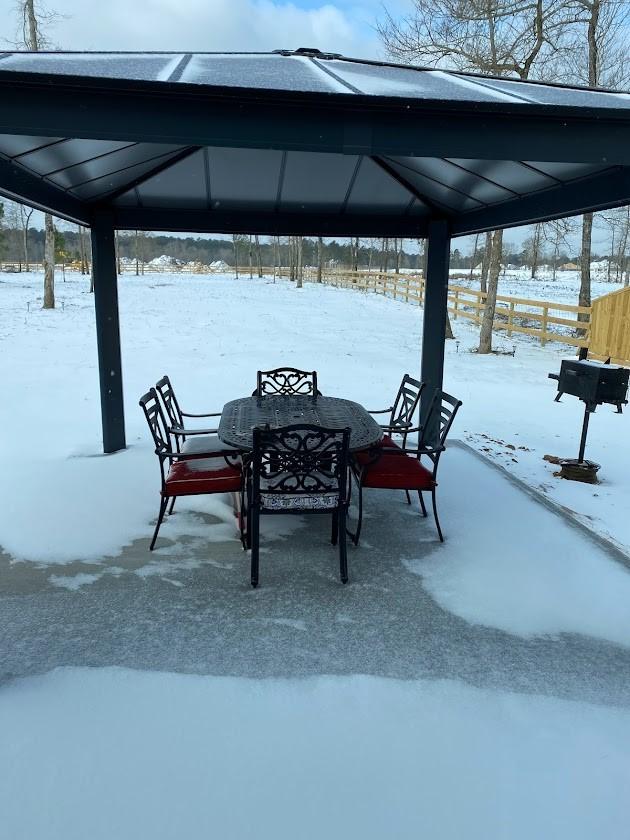 snow covered patio with a gazebo