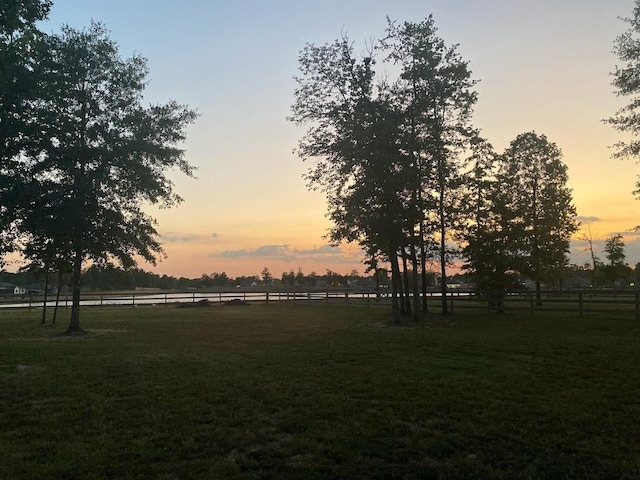 yard at dusk with a rural view