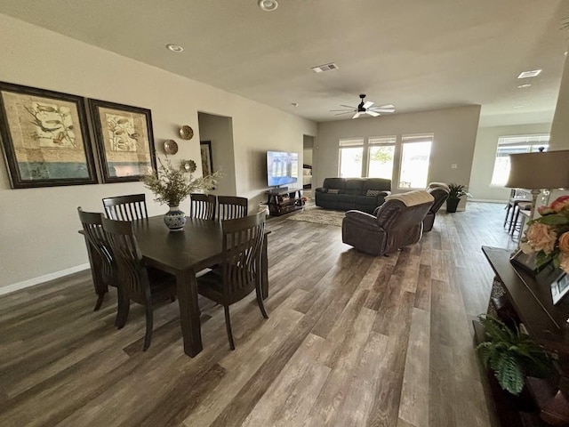 dining space with dark wood-type flooring and ceiling fan