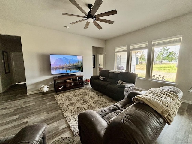 living room with dark hardwood / wood-style floors and ceiling fan