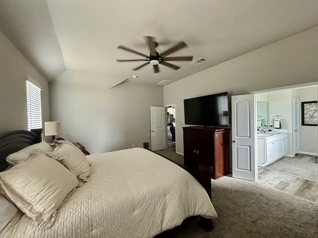 carpeted bedroom with ceiling fan and vaulted ceiling