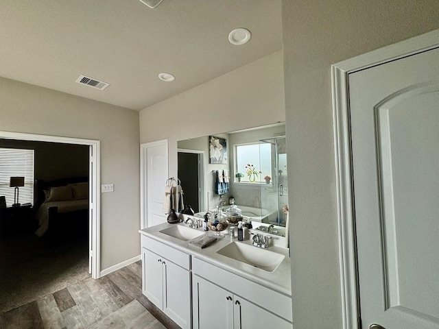 bathroom with vanity, hardwood / wood-style flooring, and separate shower and tub