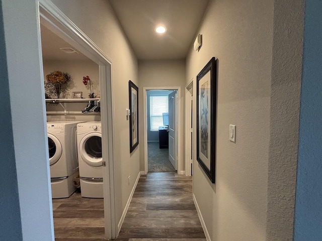 laundry room with washer and dryer and dark hardwood / wood-style flooring