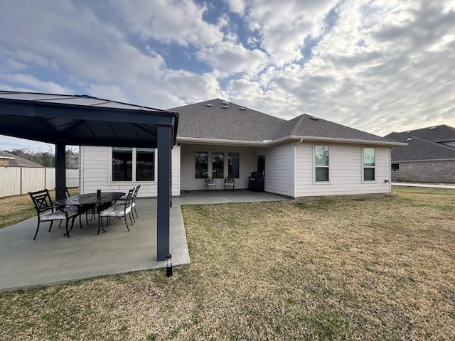 back of property featuring a gazebo, a lawn, and a patio