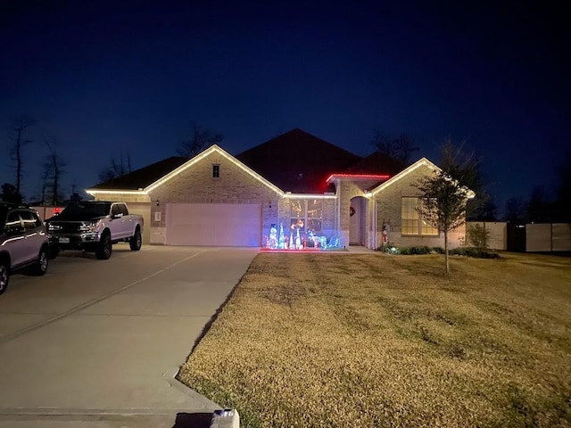 view of front of house with a garage and a lawn