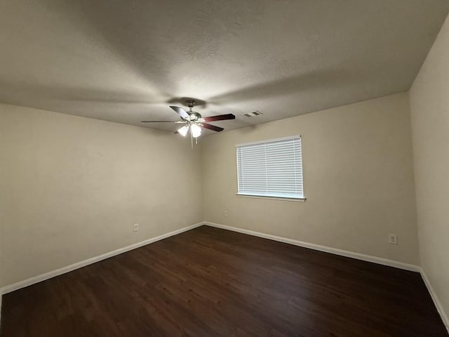 spare room with ceiling fan, dark hardwood / wood-style flooring, and a textured ceiling