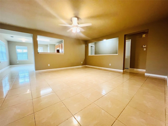 empty room featuring light tile patterned flooring and ceiling fan