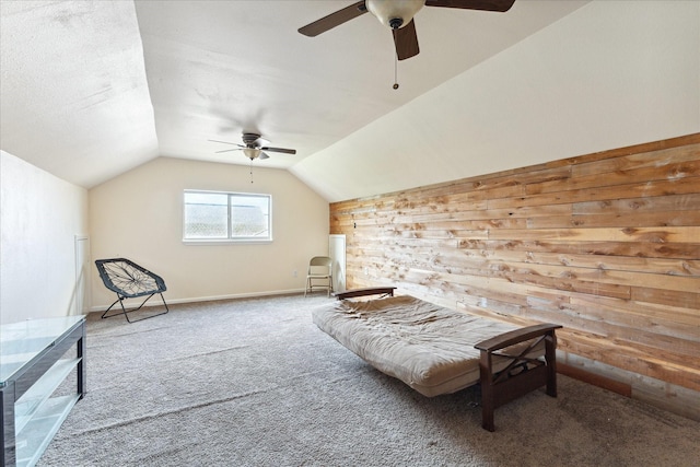 living area featuring vaulted ceiling, wooden walls, and carpet floors